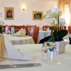 Ristorante con tavoli apparecchiati e decorazioni floreali.